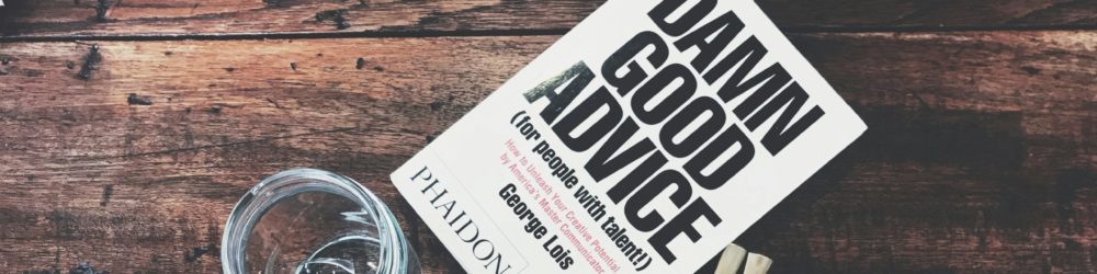 Damn Good Advice book on a wooden table